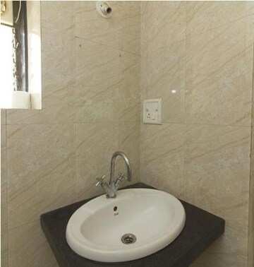 Bathroom in 3 BHK Apartment at Bhartiya Rakshak Adhikari CHS, Andheri West – for Rent