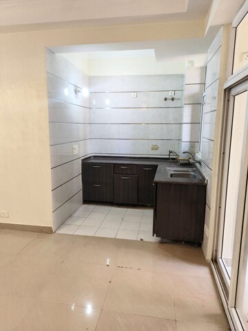 Kitchen in 2.5 BHK Apartment at Amrapali Princely Estate, Sector 76 – for Sale
