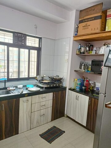 Kitchen in 2 BHK Apartment at Unnati Woods CHS, Kasarvadavali – for Sale