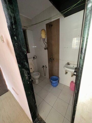 Bathroom in 2 BHK Apartment at Unnati Woods CHS, Kasarvadavali – for Sale