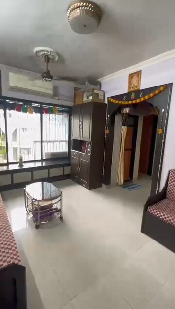 Living Room in 1 BHK Apartment at Om Krishna CHS, Dahisar East – for Sale