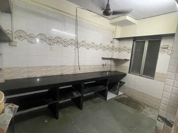 Kitchen in 1 BHK Apartment at Suvarnadurg CHS, Borivali East – for Sale
