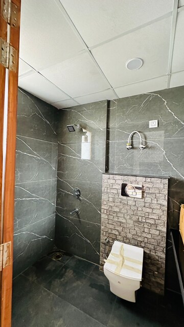Bathroom in 3 BHK Apartment at Green Valley Heights, Dhakoli Village – for Sale