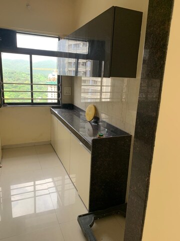 Kitchen in 1 BHK Apartment at Raunak Unnathi Woods Phase 6, Ghodbunder Road – for Sale