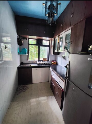 Kitchen in 1 BHK Apartment at Raunak Unnathi Woods Phase 4 And 5, Ghodbunder Road – for Sale