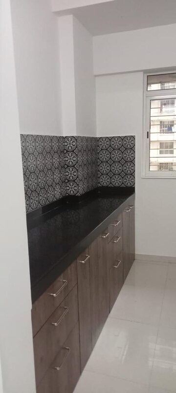 Kitchen in 2 BHK Apartment at Harmony Signature Towers, Owale – for Rent