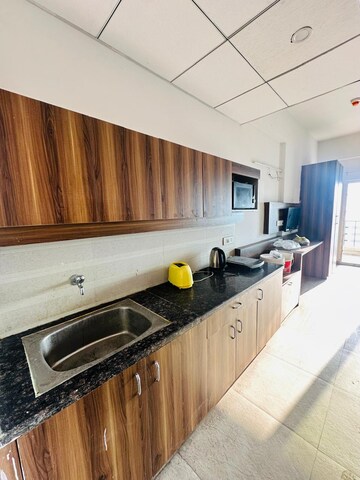 Kitchen in 1 RK Apartment at Paramount Golf Foreste Apartments, Zeta I Greater Noida – for Rent
