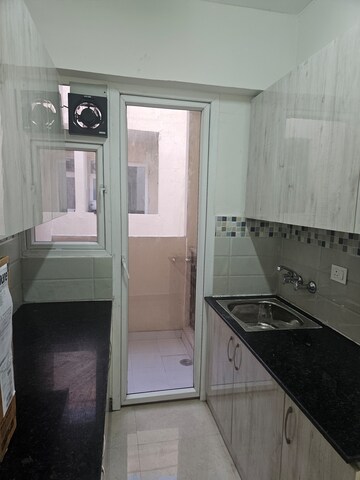 Kitchen in 2 BHK Apartment at Signature Global Orchard Avenue, Sector 93 – for Rent