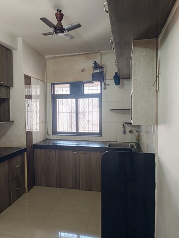 Kitchen in 2 BHK Apartment at Unnati Woods CHS, Kasarvadavali – for Sale