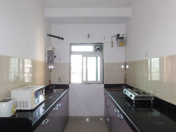 Kitchen in 2 BHK Apartment at Rustomjee Urbania Aurelia, Majiwada – for Rent