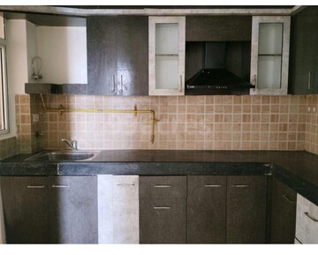 Kitchen in 2 BHK Apartment at Mahagun Mywoods, Sector 16c Greater Noida – for Rent