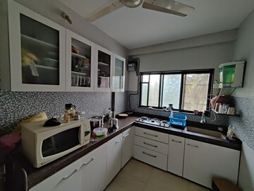 Kitchen in 2 BHK Apartment at Ani Anu Sri Balaji Enclave, Malad West – for Sale