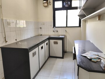 Kitchen in 2 BHK Apartment at Rodas Enclave Woodstock, Patlipada – for Rent