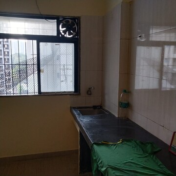 Kitchen in 1 BHK Apartment at Raunak Unnathi Woods Phase 4 And 5, Ghodbunder Road – for Sale