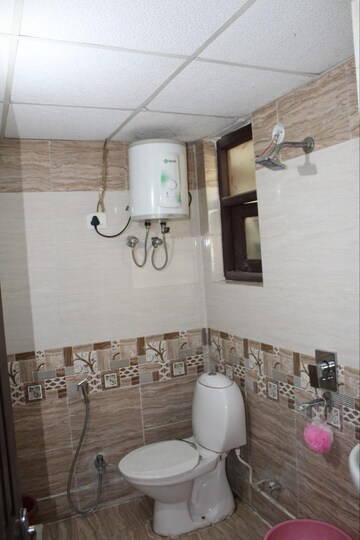 Bathroom in 3 BHK Apartment at Raj Nagar Extension – for Sale