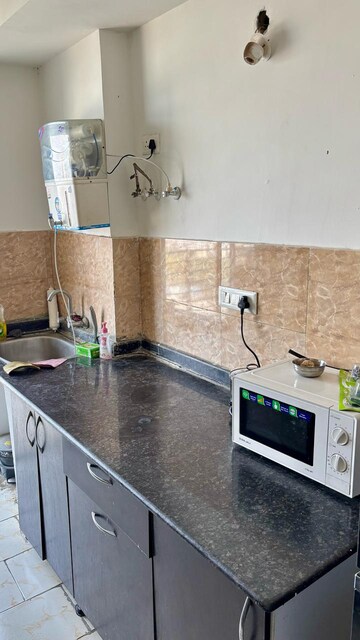Kitchen in 3.5 BHK Apartment at Aims Golf City, Sector 75 – for Rent