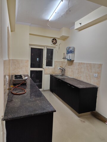 Kitchen in 2.5 BHK Apartment at Aims Golf City, Sector 75 – for Rent