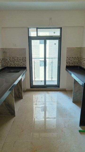 Kitchen in 1 BHK Apartment at Raunak Unnathi Woods Phase 7 A And B, Ghodbunder Road – for Rent