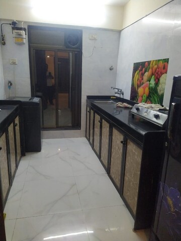Kitchen in 2 BHK Apartment at Rohit Towers, Malad West – for Rent