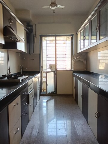 Kitchen in 2 BHK Apartment at Nilgiri Upvan CHS, Gawand Baug – for Rent