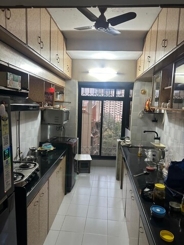 Kitchen in 2 BHK Apartment at Ani Anu Sri Balaji Enclave, Malad West – for Sale