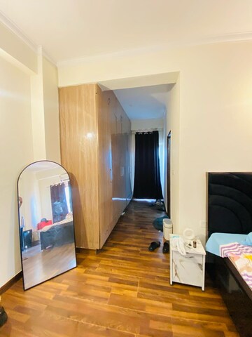 Living Room in 2.5 BHK Apartment at Aims Golf City, Sector 75 – for Rent