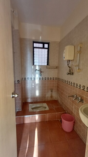 Bathroom in 2 BHK Apartment at Raunak Paradise, Kokanipada – for Rent