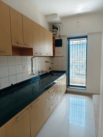 Kitchen in 2 BHK Apartment at Venus Upvan CHS, Gawand Baug – for Rent