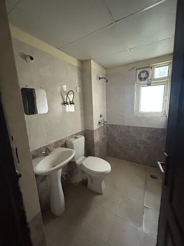 Bathroom in 2 BHK Apartment at Aims Golf City, Sector 75 – for Sale