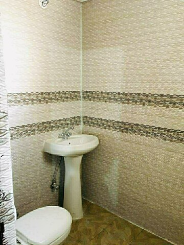 Bathroom in 1 BHK Apartment at Nilaya Greens, Raj Nagar Extension – for Rent