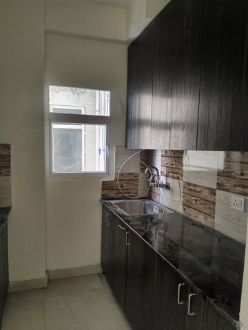 Kitchen in 2 BHK Apartment at Amrapali Enchante, Tech Zone 4 Greater Noida – for Rent