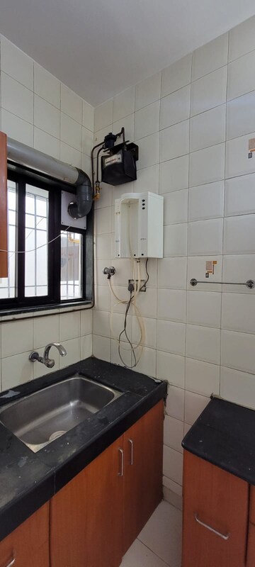 Kitchen in 3 BHK Apartment at Swojas Sarthak, Law College Road – for Rent