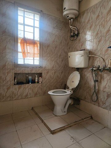 Bathroom in 2 BHK Apartment at RWA Qutab Enclave, Katwaria Sarai – for Rent