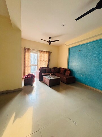 Living Room in 2.5 BHK Apartment at Aims Golf City, Sector 75 – for Rent