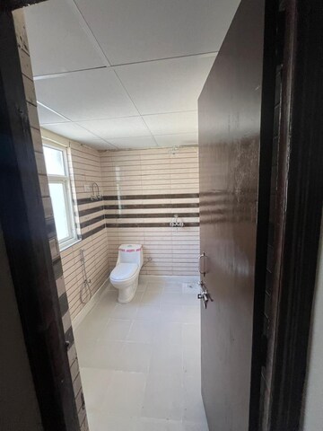 Bathroom in 2.5 BHK Apartment at Aims Golf City, Sector 75 – for Sale