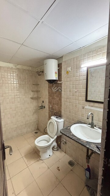 Bathroom in 2 BHK Apartment at Aims Golf City, Sector 75 – for Rent