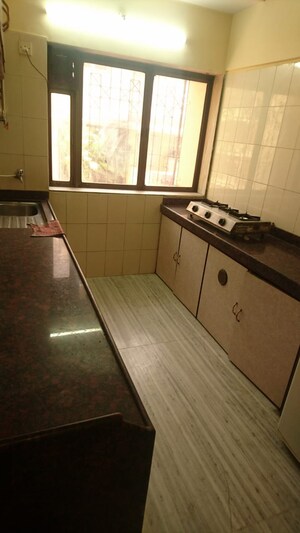 Kitchen in 2 BHK Apartment at Ani Anu Sri Balaji Enclave, Malad West – for Sale