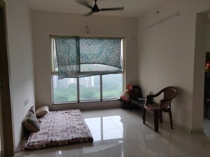 Living Room in 1 BHK Apartment at Godrej Nirvaan, Themghar – for Sale