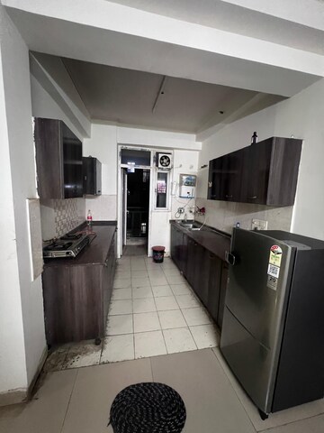 Kitchen in 2.5 BHK Apartment at Aims Golf City, Sector 75 – for Rent