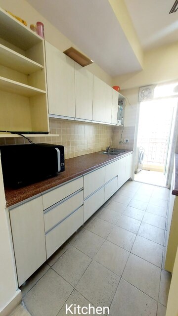Kitchen in 3 BHK Apartment at Mahagun Moderne, Sector 78 – for Rent
