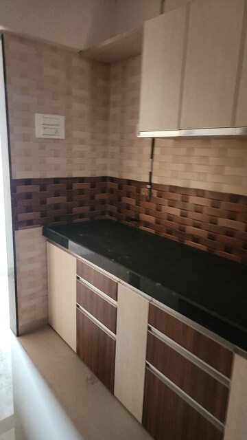 Kitchen in 2 BHK Apartment at Shree Tirupati STG Signature Residency, Patlipada – for Rent