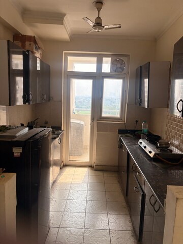 Kitchen in 2.5 BHK Apartment at Aims Golf City, Sector 75 – for Rent