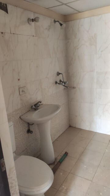 Bathroom in 2 BHK Apartment at Aims Golf City, Sector 75 – for Sale