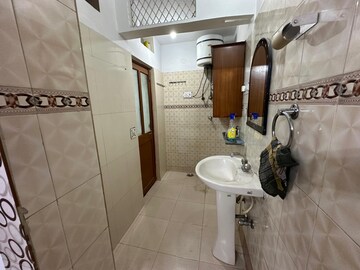 Bathroom in 3 BHK Apartment at RWA Qutab Enclave, Katwaria Sarai – for Rent