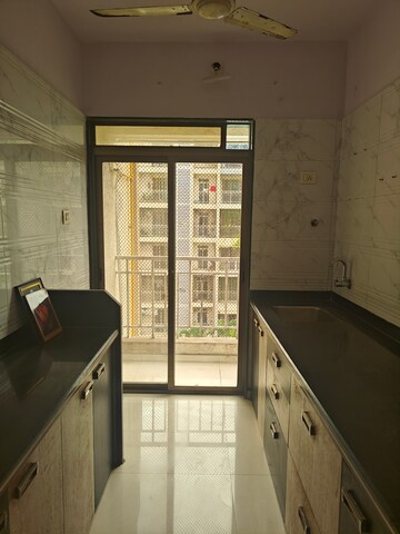 Kitchen in 2 BHK Apartment at Om Prabhu Manohar CHS, Seawoods Sector 50 – for Rent