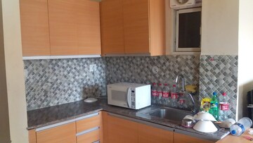 Kitchen in Studio Apartment at Supertech Czar Suites, Omicron I Greater Noida – for Rent