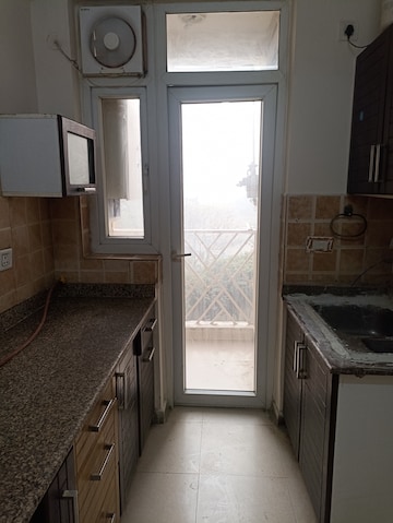Kitchen in 2 BHK Apartment at Amrapali Eden Park, Sector 50 – for Rent