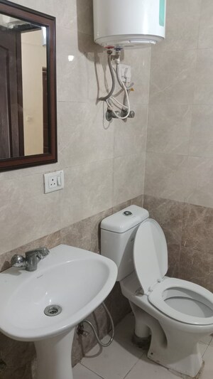 Bathroom in 2.5 BHK Apartment at Aims Golf City, Sector 75 – for Sale