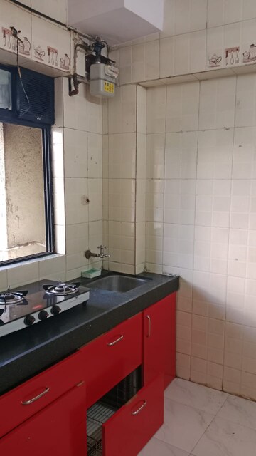 Kitchen in 1 BHK Apartment at Raunak Unnathi Woods Phase 4 And 5, Ghodbunder Road – for Rent