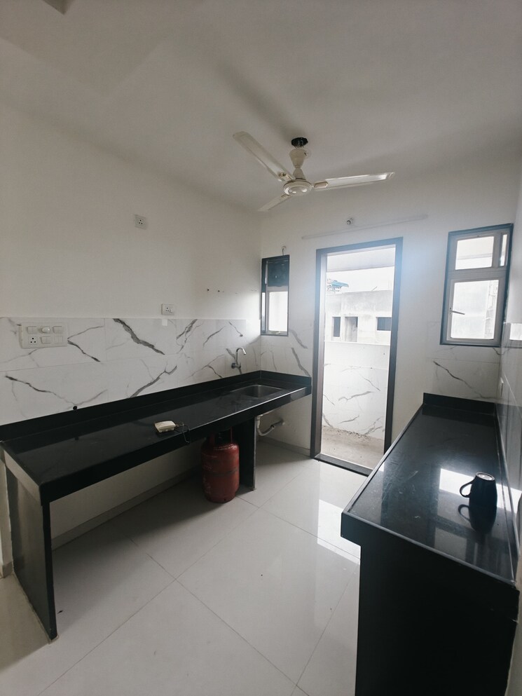 Kitchen, blue-27th-avenue 2 Bedroom 730 Sq.Ft. Apartment In Bavdhan Pune 9015110